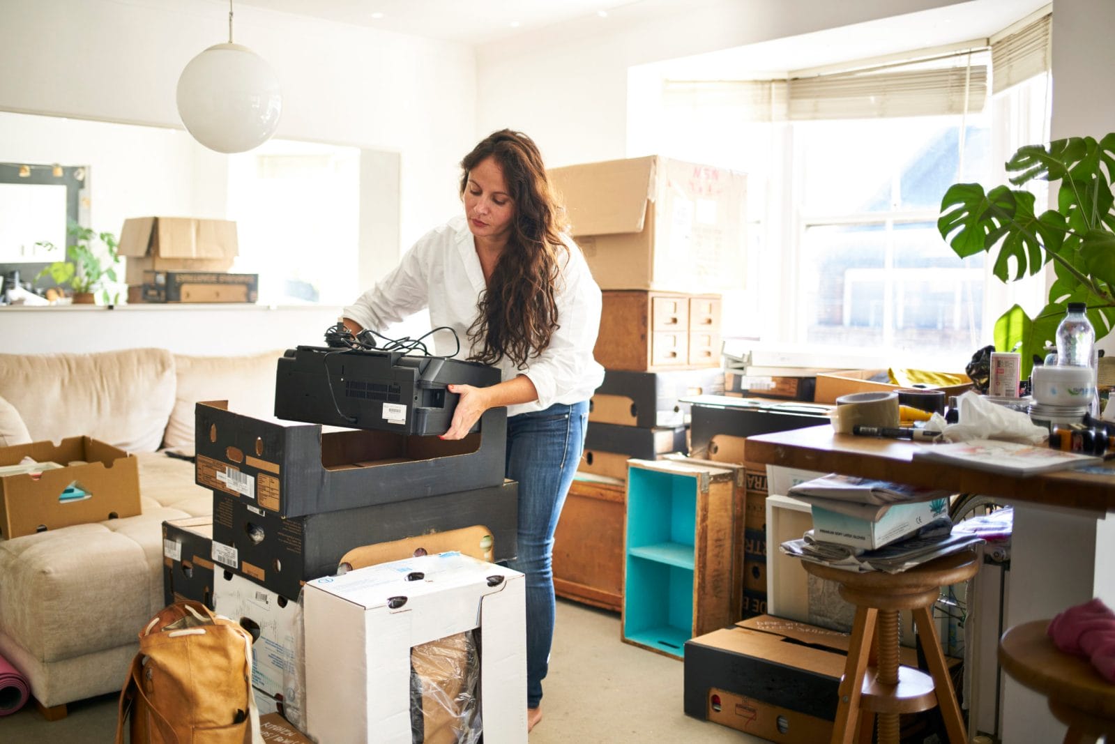 20 ways you can stop chronic household clutter *right now* woman decluttering home