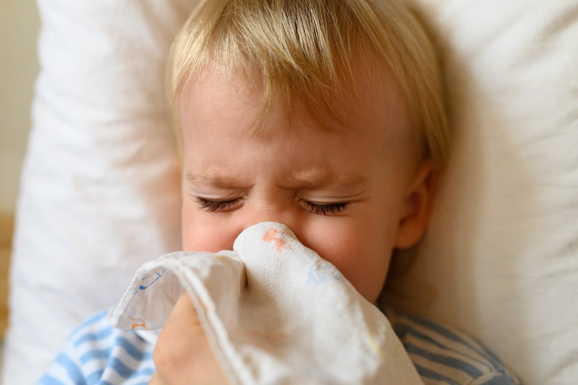 What to do when your child has the flu child blowing his nose