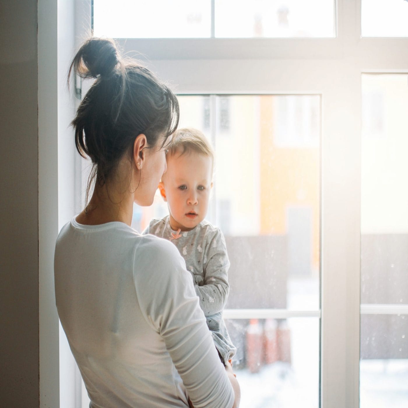 Why America needs to consider paying stay-at-home parents mom holding baby