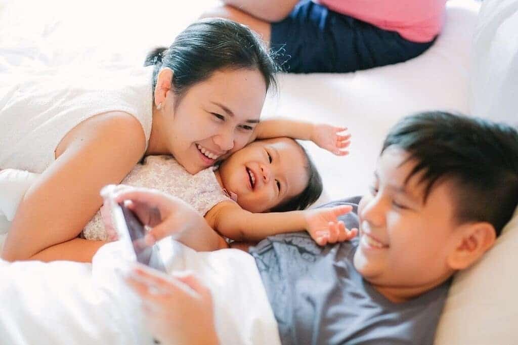 27 ways to show your kids you love them on Valentine’s Day (or any day) mom smiling with daughter and son- children's 5 love languages