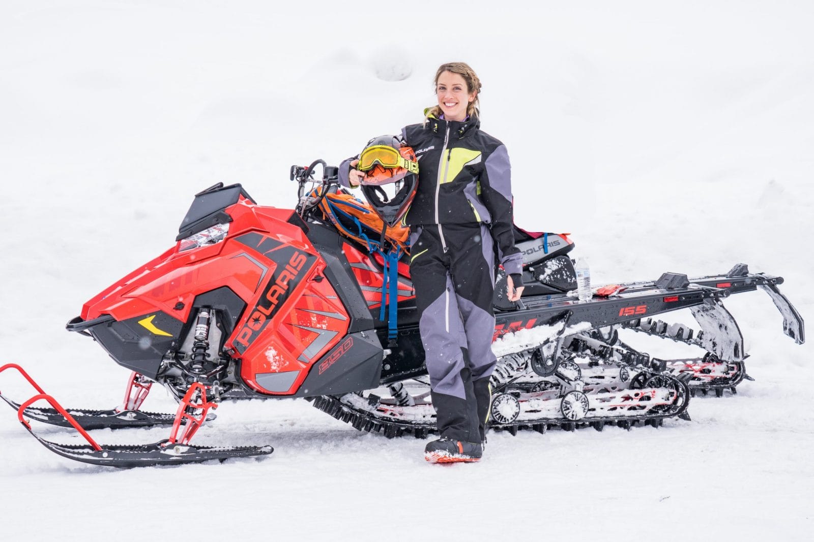 My first trip away from my baby taught me I can handle anything woman standing next to a snowmobile
