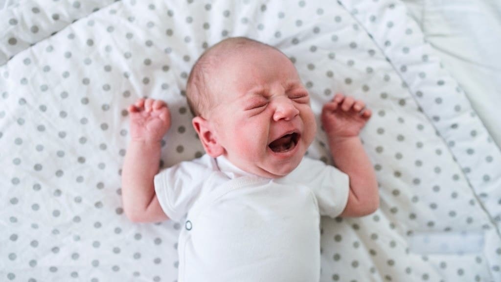 Colic 101: What it is & what you can do to make it better baby crying in a crib