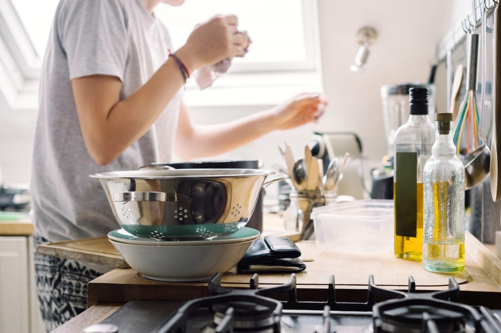 Top cleaning tips to help protect your family against the coronavirus woman cleaning the kitchen