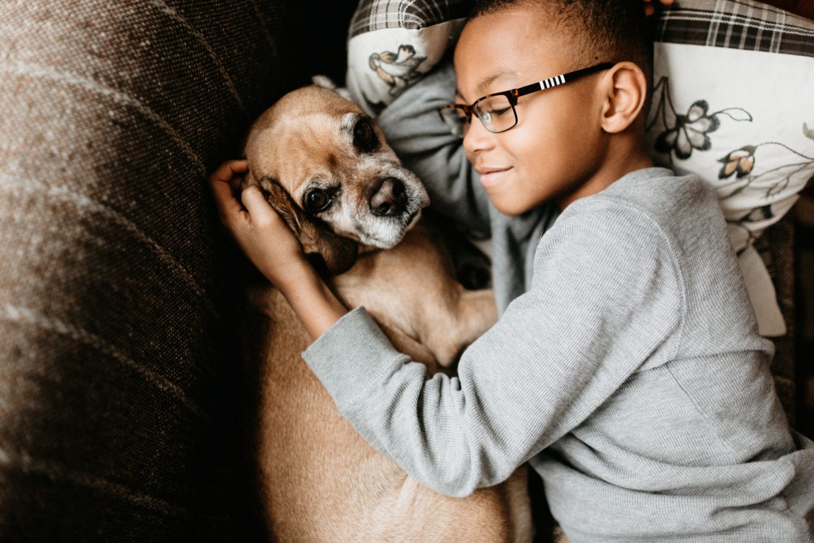 10 phrases parents can use to help kids understand social distancing child hugging a dog on the couch