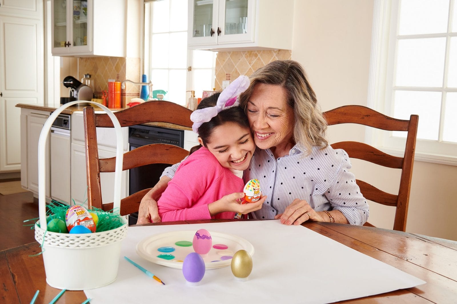 5 ways to create a memorable Easter basket for your kids mom hugging daughter while coloring Easter eggs