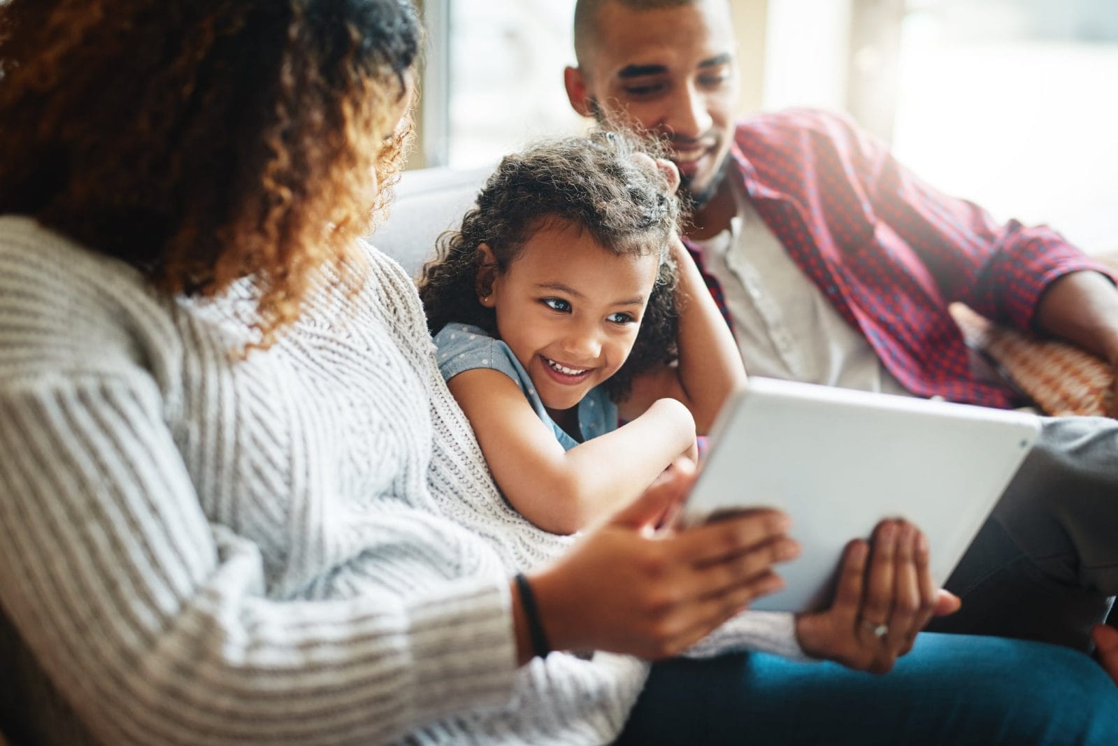 These 12 movies are releasing early so you can watch at home 🙌 family watching a movie together on an ipad