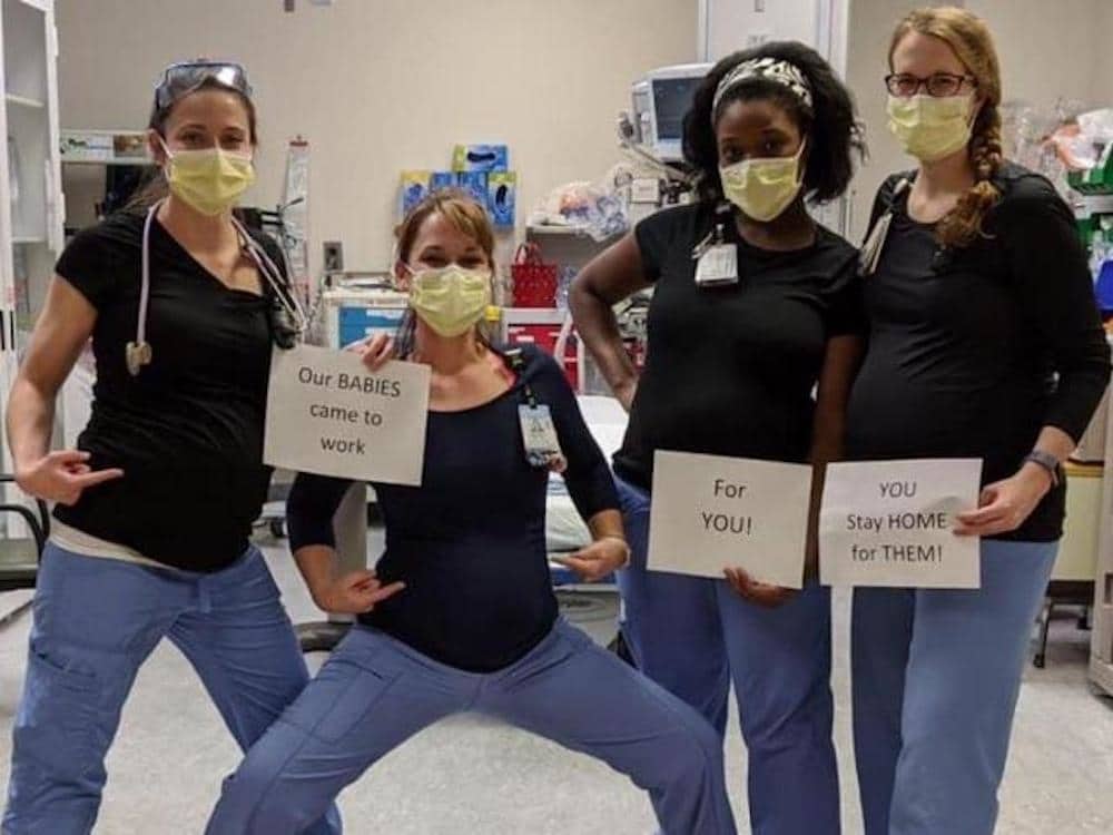 These pregnant ER nurses share an important message about coronavirus pregnant nurses holding signs asking people to stay home