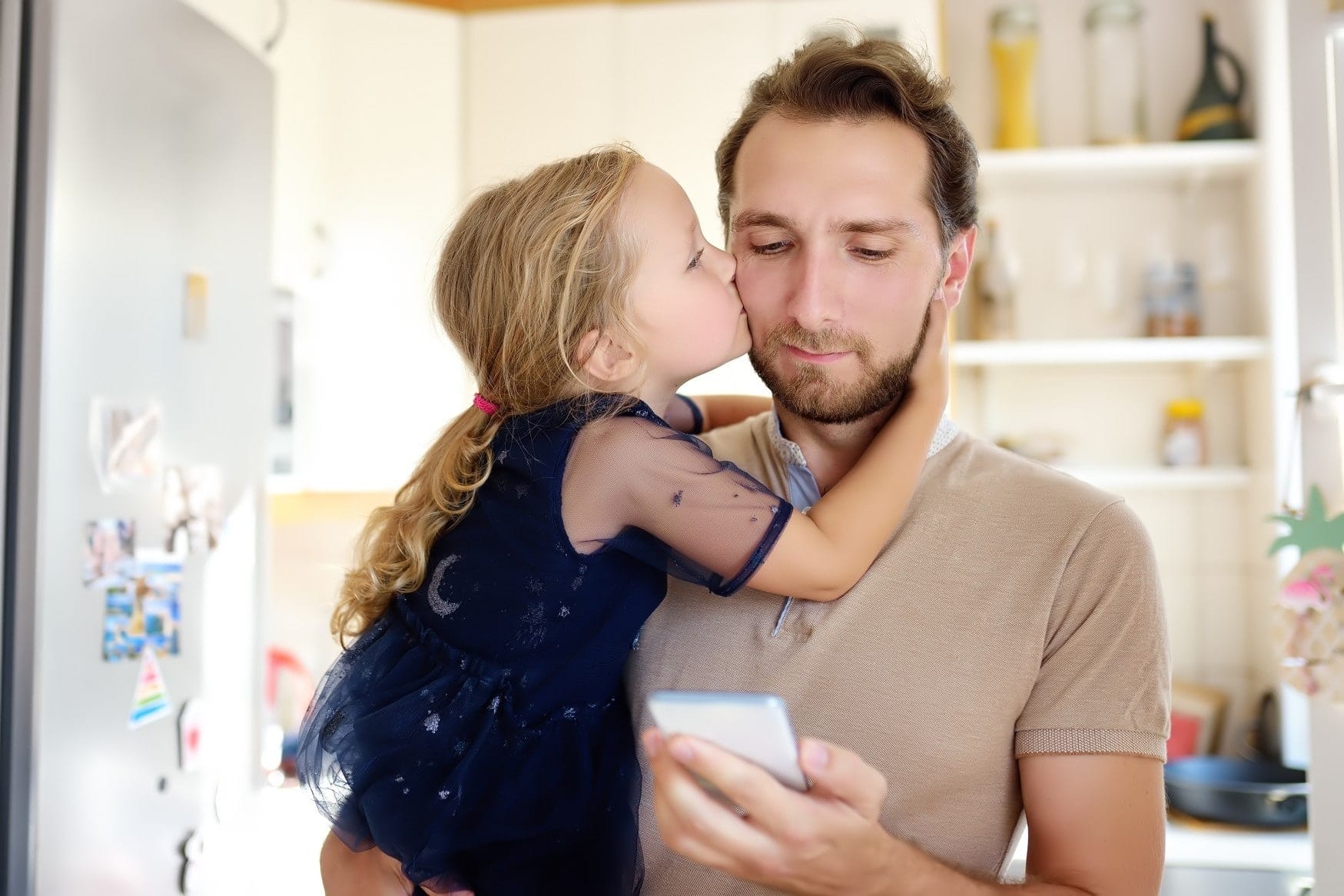 7 expert tips for co-parenting through the coronavirus pandemic little girl kissing dad on the cheek