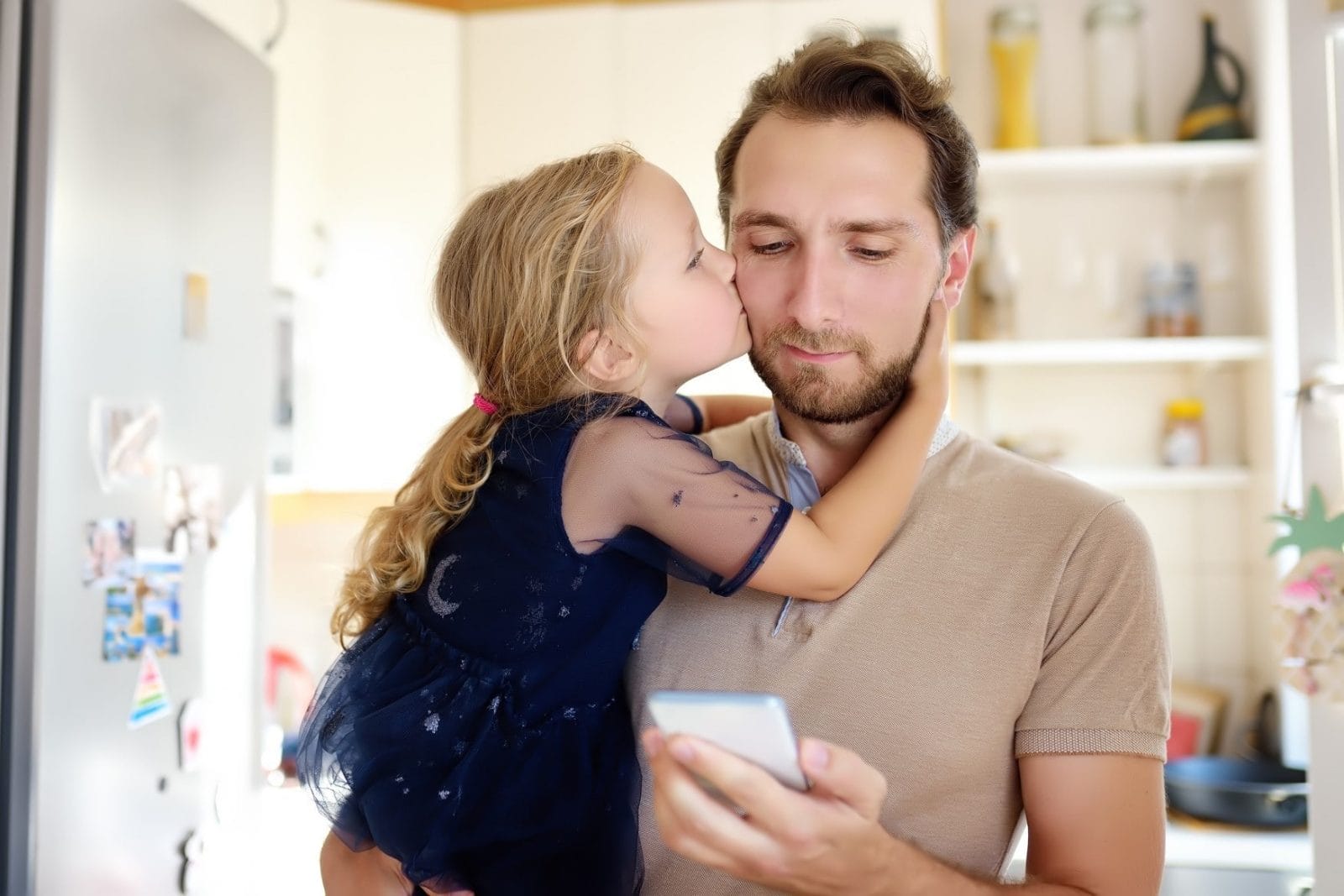 7 expert tips for co-parenting through the coronavirus pandemic little girl kissing dad on the cheek
