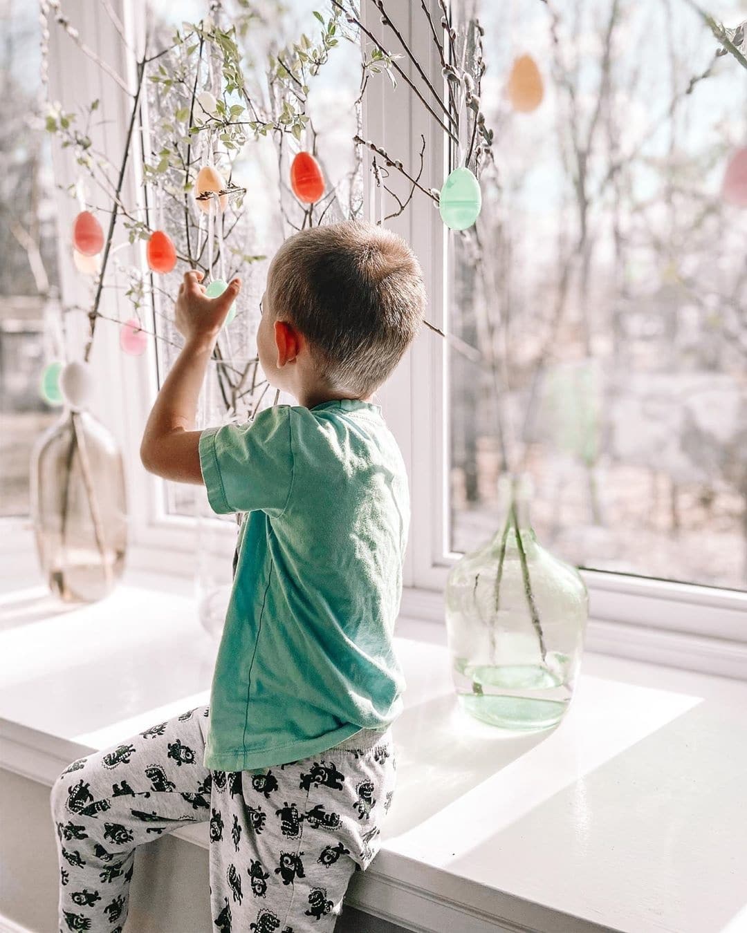 Easter trees are bringing a much-needed dose of cheer to families in isolation little boy playing with easter trees