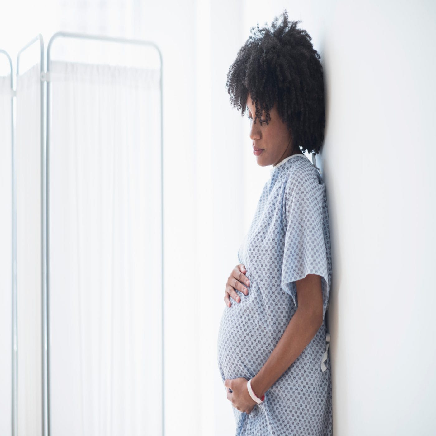 Black women will suffer the most if forced to give birth alone pregnant woman holding her belly
