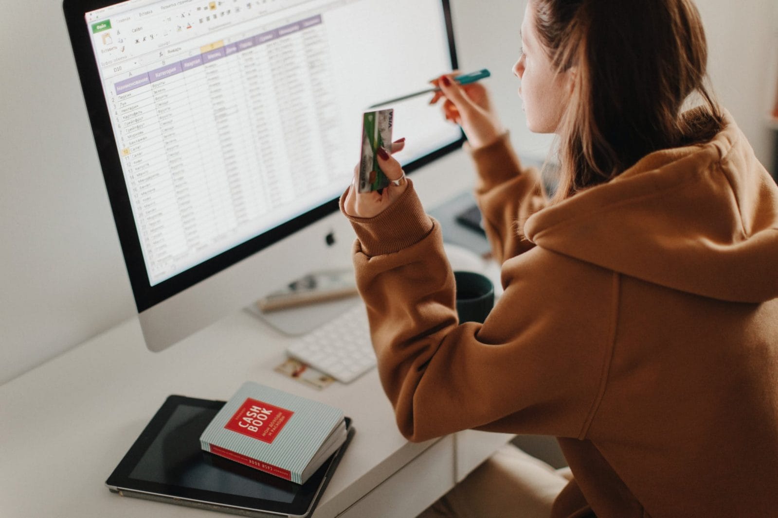 What to do if you can’t pay your bills right now woman working on a budget on a computer