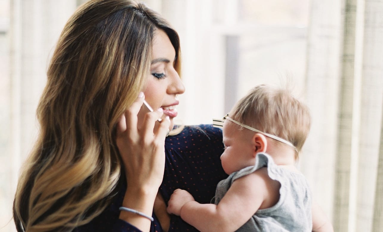 9 tips for going back to work from maternity leave during COVID-19 mom on the phone while holding a baby