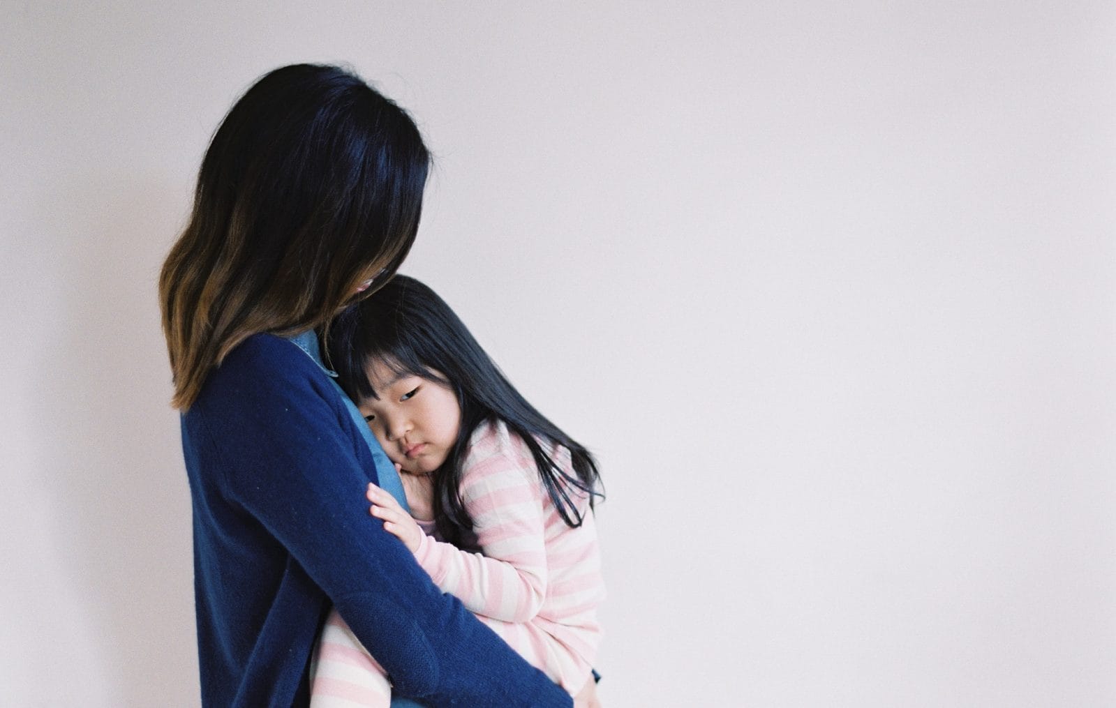 8 phrases that help kids deal with disappointment mom holding a sad toddler