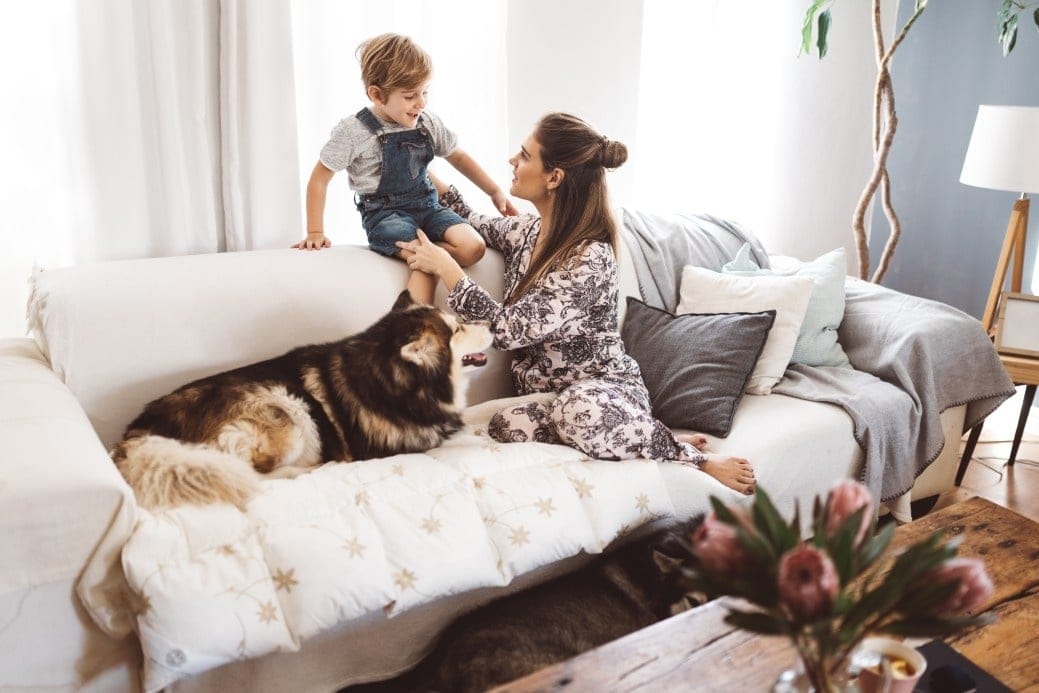 10 questions kids have about coronavirus (& how to answer them) mom talking to son on bed