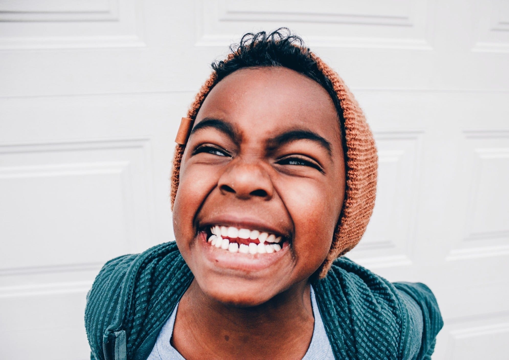 How to raise an optimistic child in a pessimistic world little girl smiling at camera
