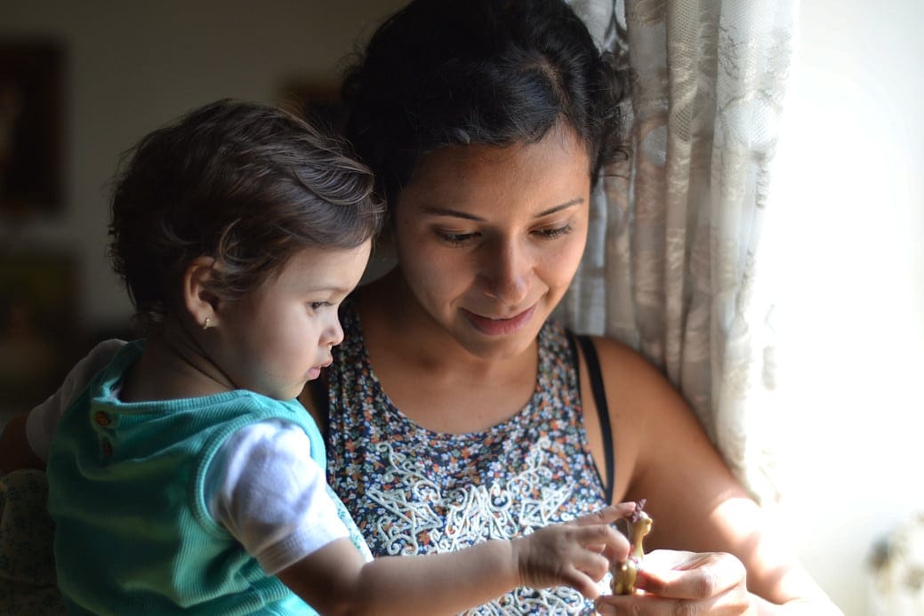 I miss saying yes mom holding daughter next to a window