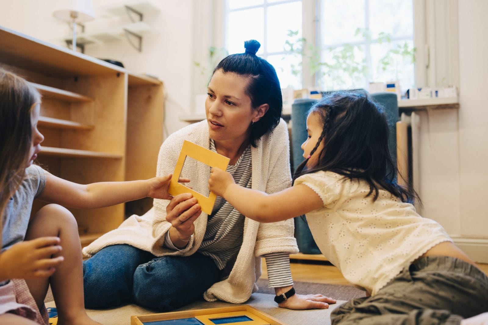 Childcare is essential for parents—but the industry is in danger kids playing with teacher at daycare