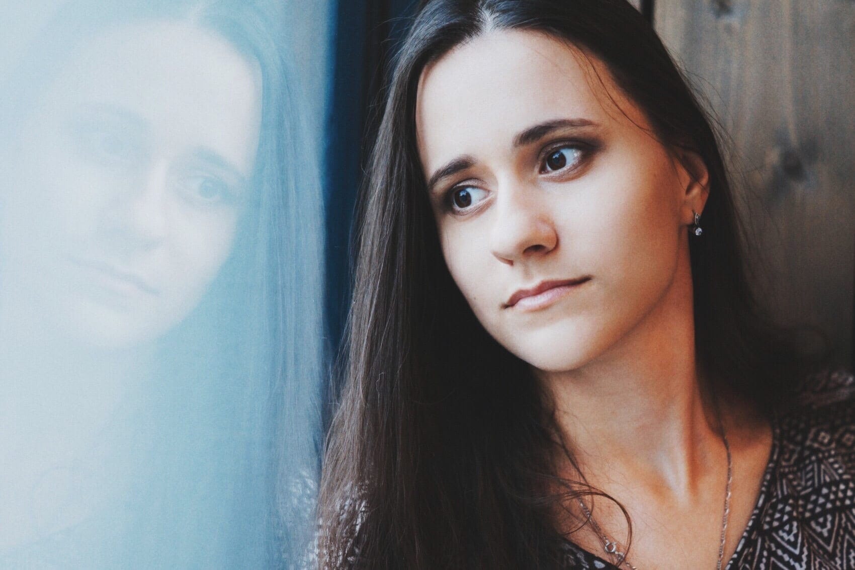 The hidden risk of postpartum depression during quarantine (and how to get help) woman looking out window