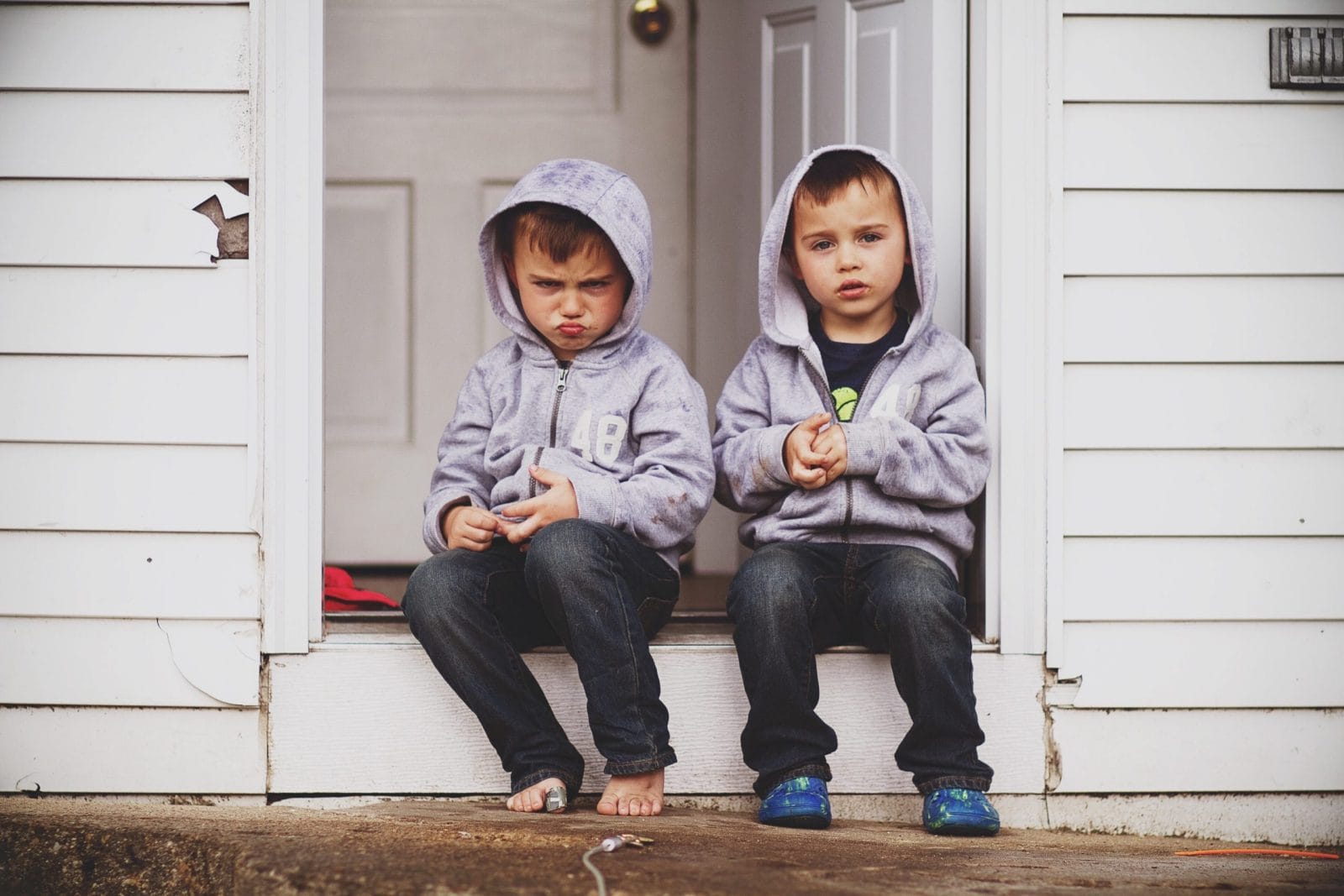 If your kids are constantly fighting, try this siblings sitting on a doorstep