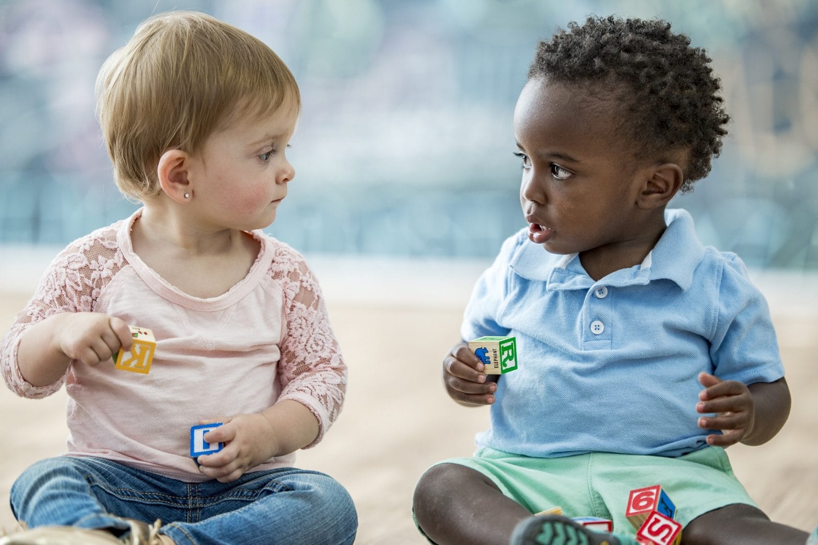 Should you send your child to day care or day camp this summer? Here’s why it’s so hard to decide two babies sitting next to each other