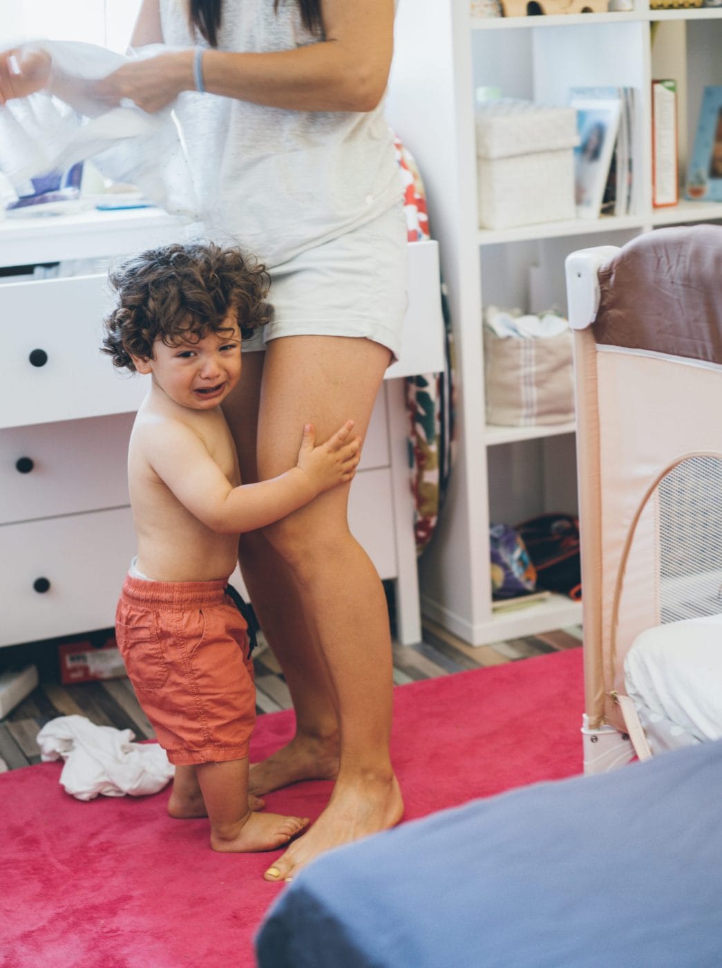 23 mom-tested ways to manage a tantrum (that really work) crying toddler hugging moms legs