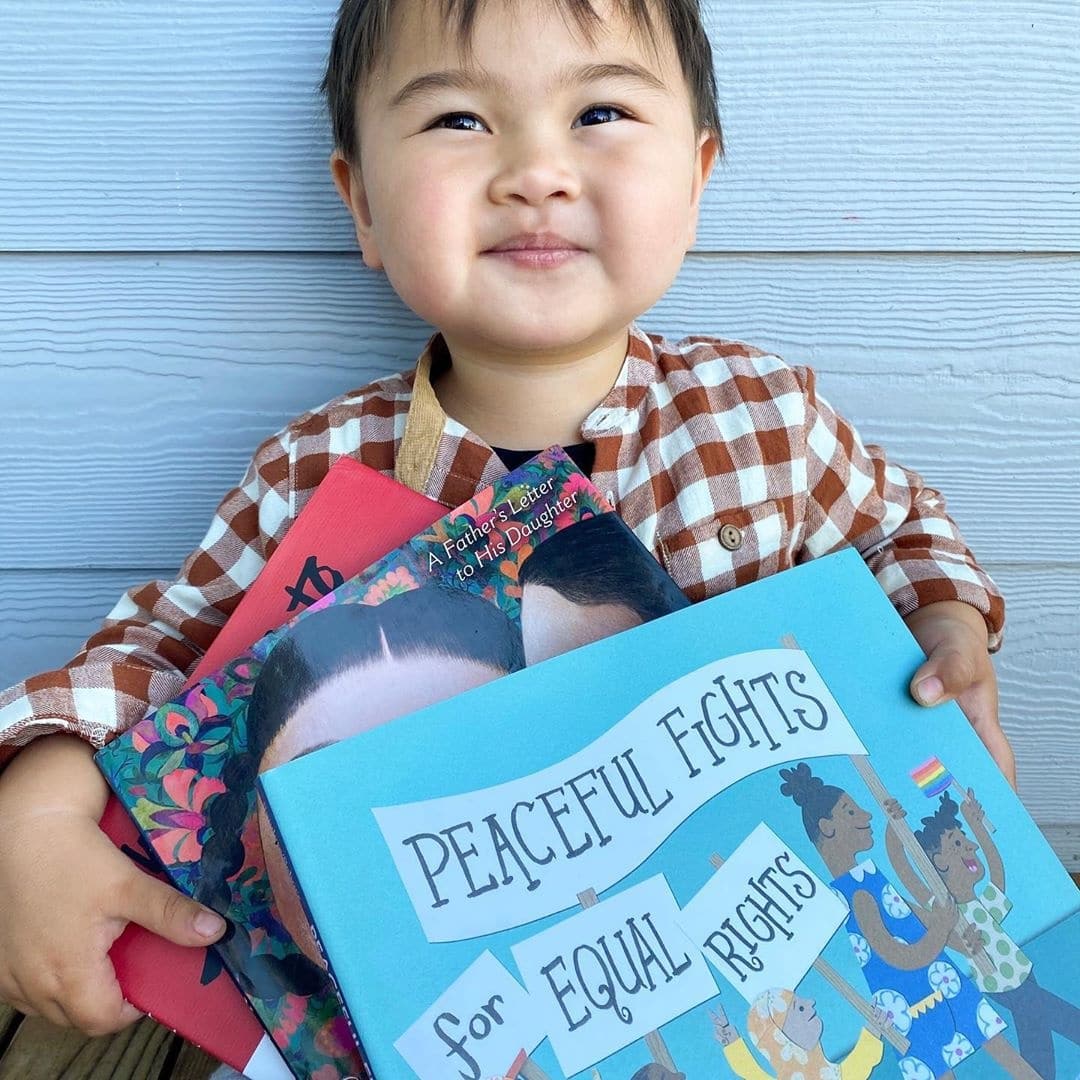 This toddler is going viral for thanking his mama (for absolutely everything) little boy holding a book