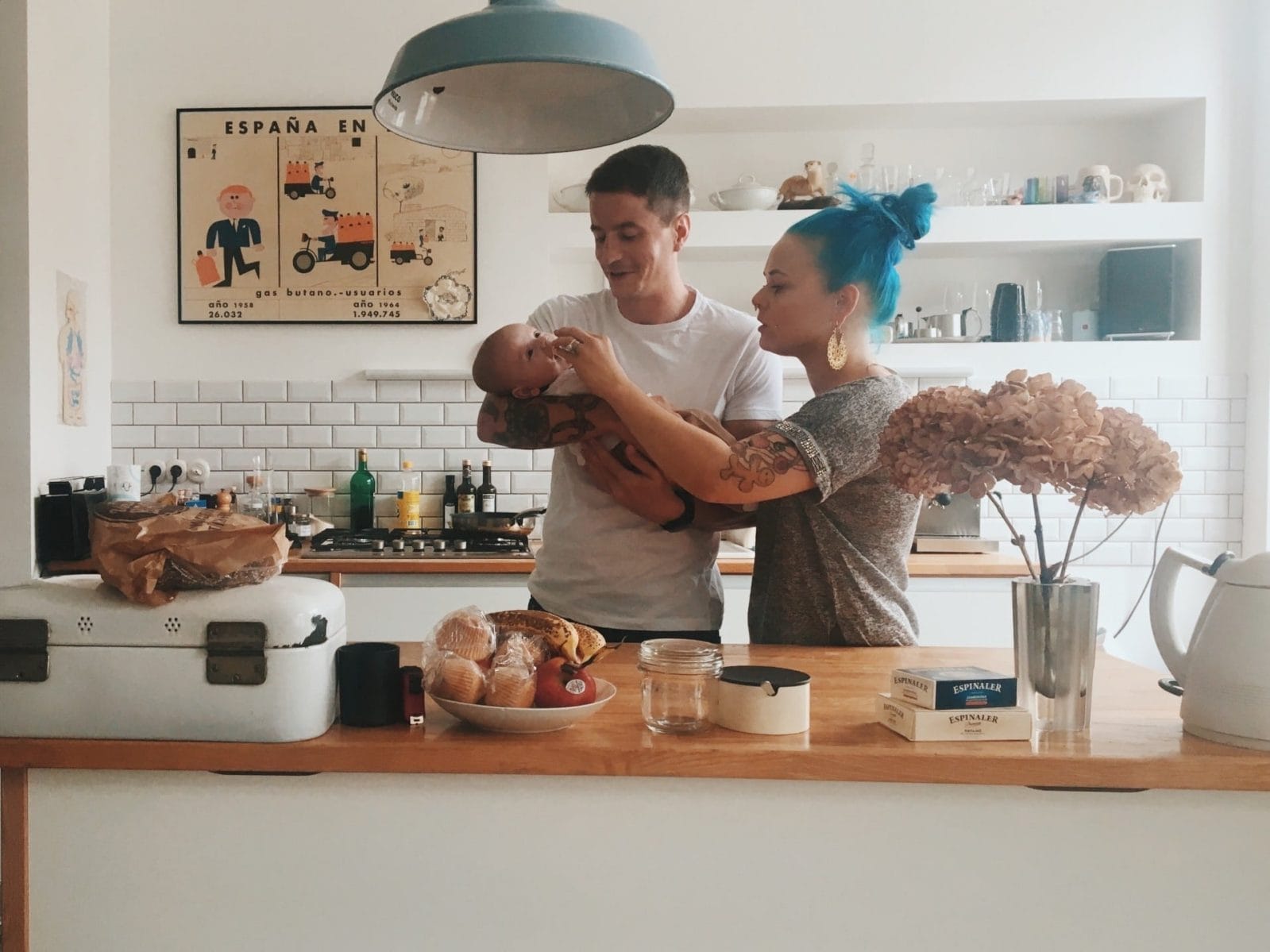 Tax deductions and credits for brand-new parents in 2020 parents looking over a newborn baby standing in their kitchen