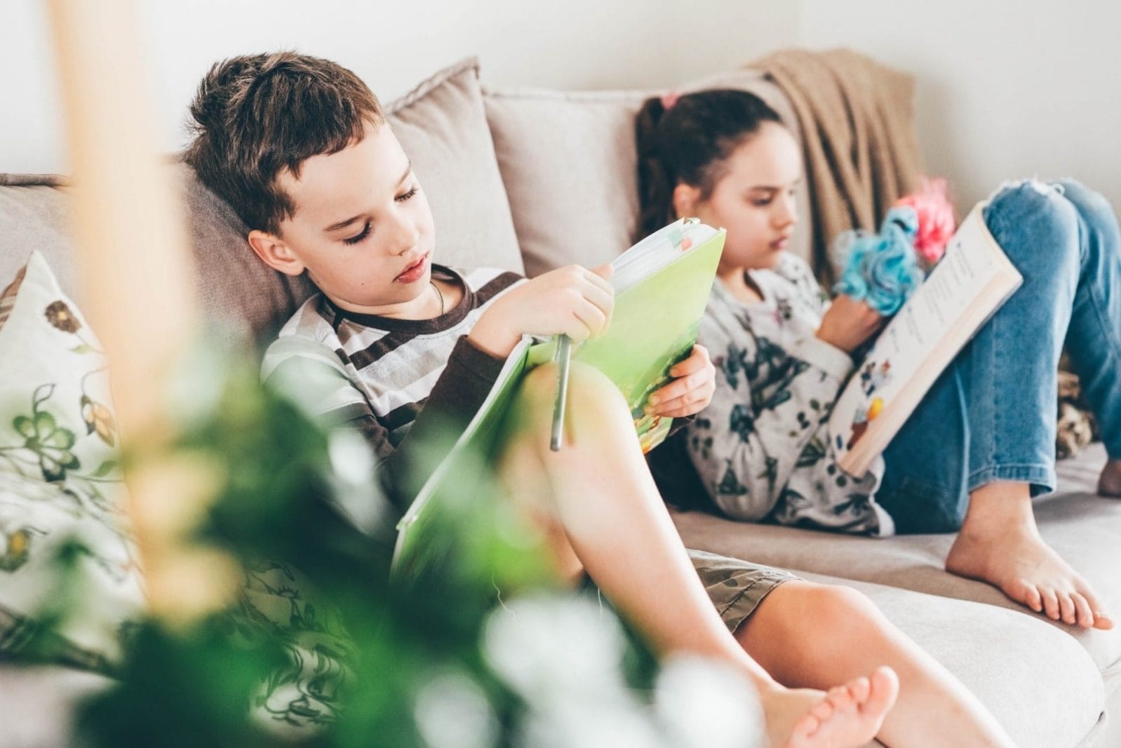 Fun summer reading list for all ages, according to a librarian two kids reading on the couch