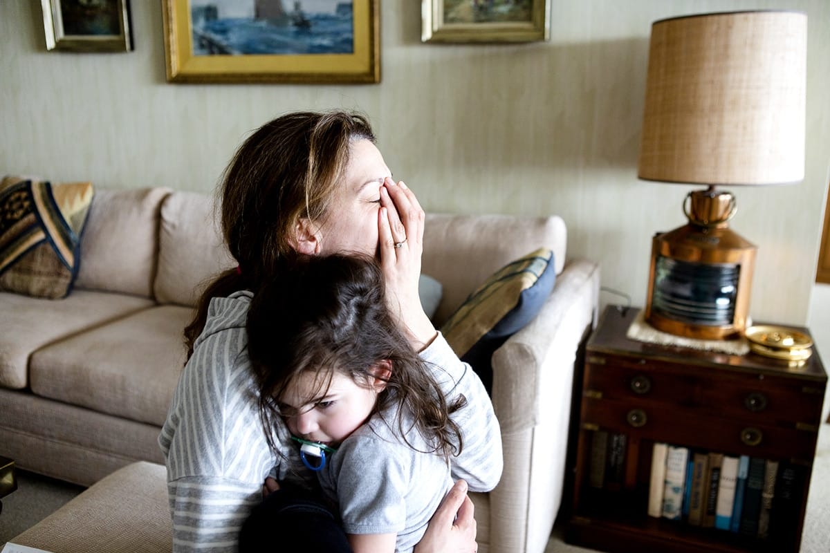 Toxic positivity doesn’t fix how much moms are burnt out—it only makes things worse mom holding her son and crying