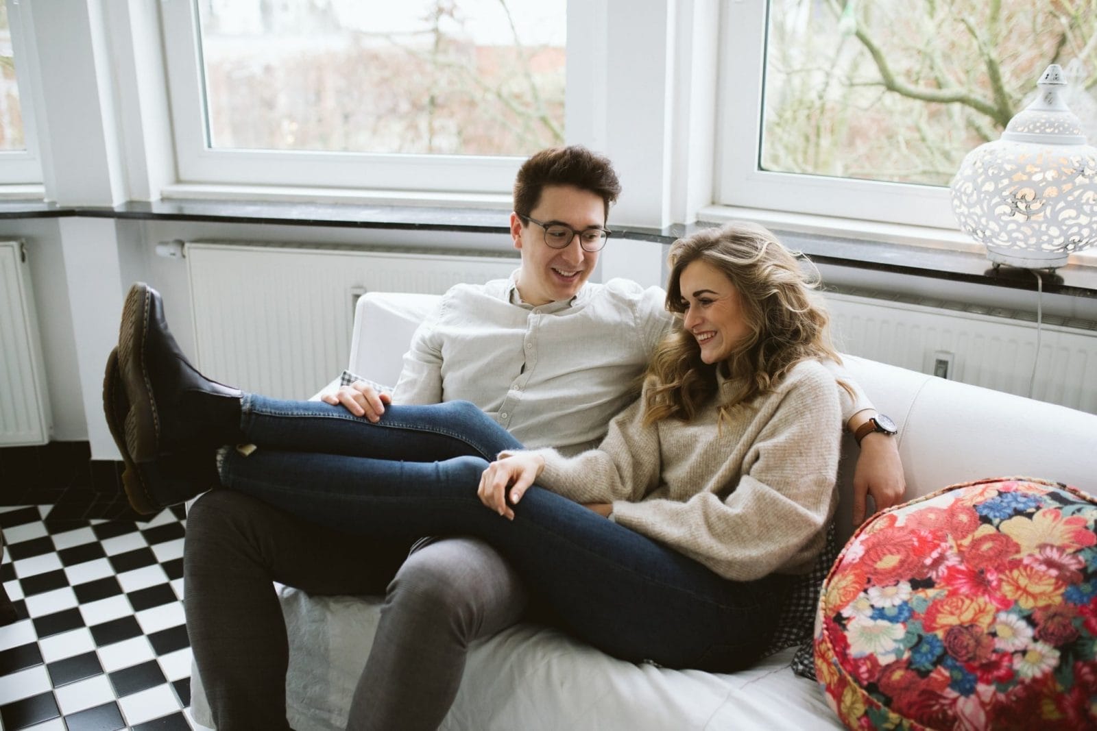 How to communicate better with your partner—starting tonight couple sitting on the couch together