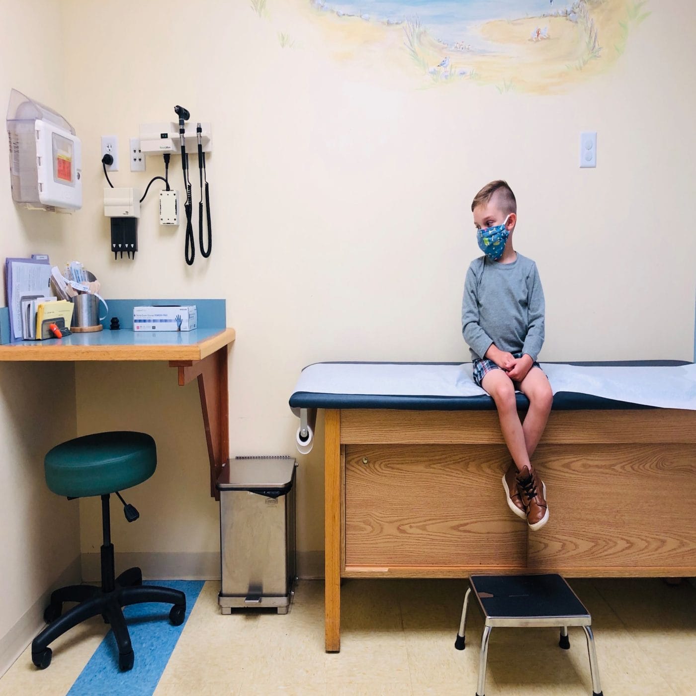 1 in 3 parents plan to skip the flu shot this year—and pediatricians are worried little boy sitting on a pediatrician table