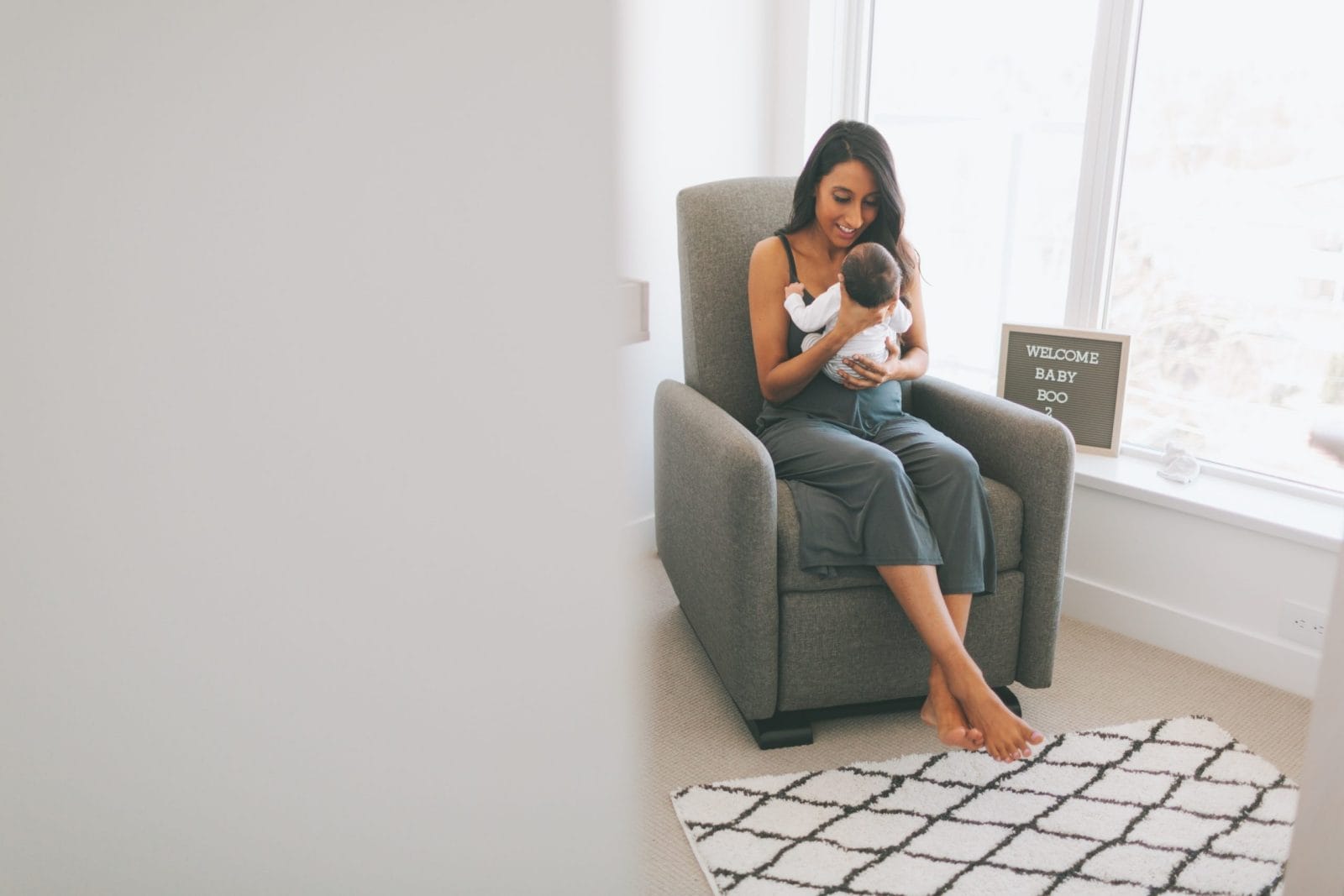 Joe Biden plans to bring 12 weeks of paid parental leave to all mom rocking newborn baby in a glider