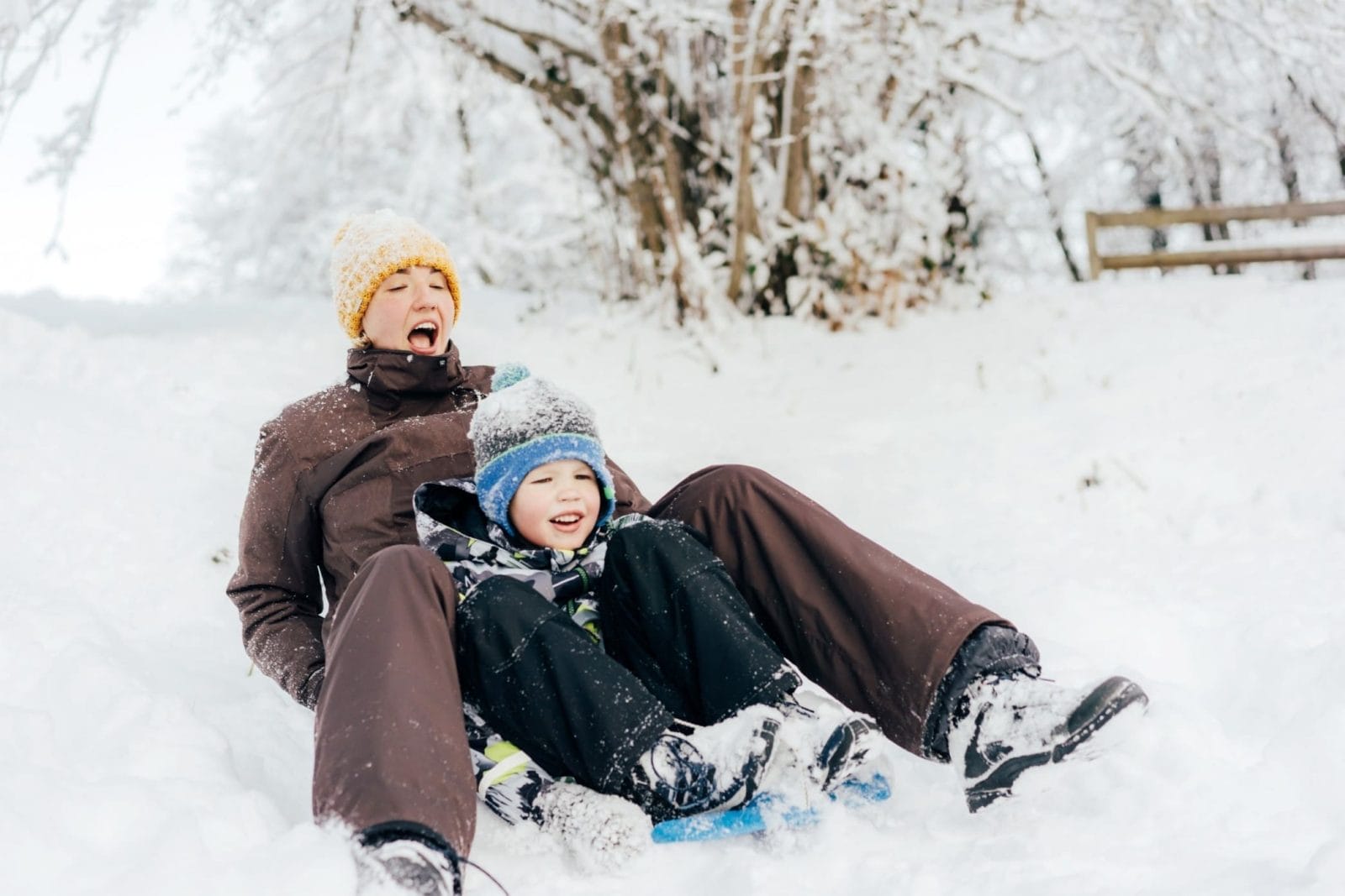 10 phrases to help kids cope with holiday disappointment this year dad and child sledding down a hill
