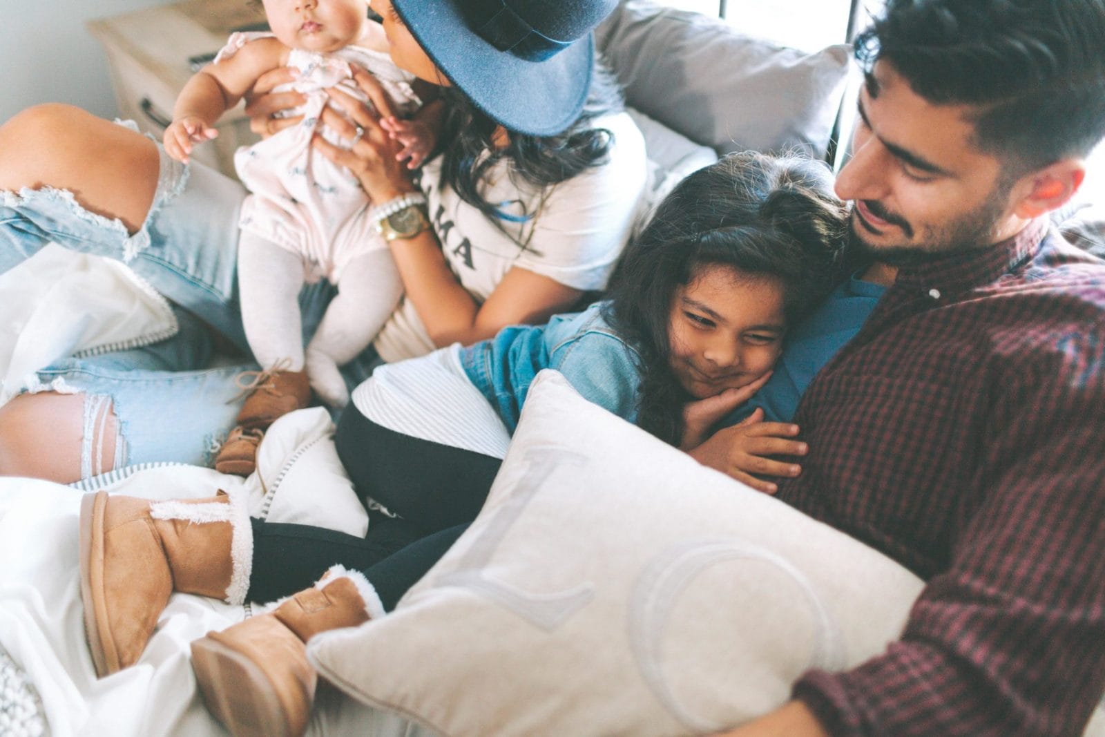8 ways to spend more time together this year family snuggled on the couch watching tv together