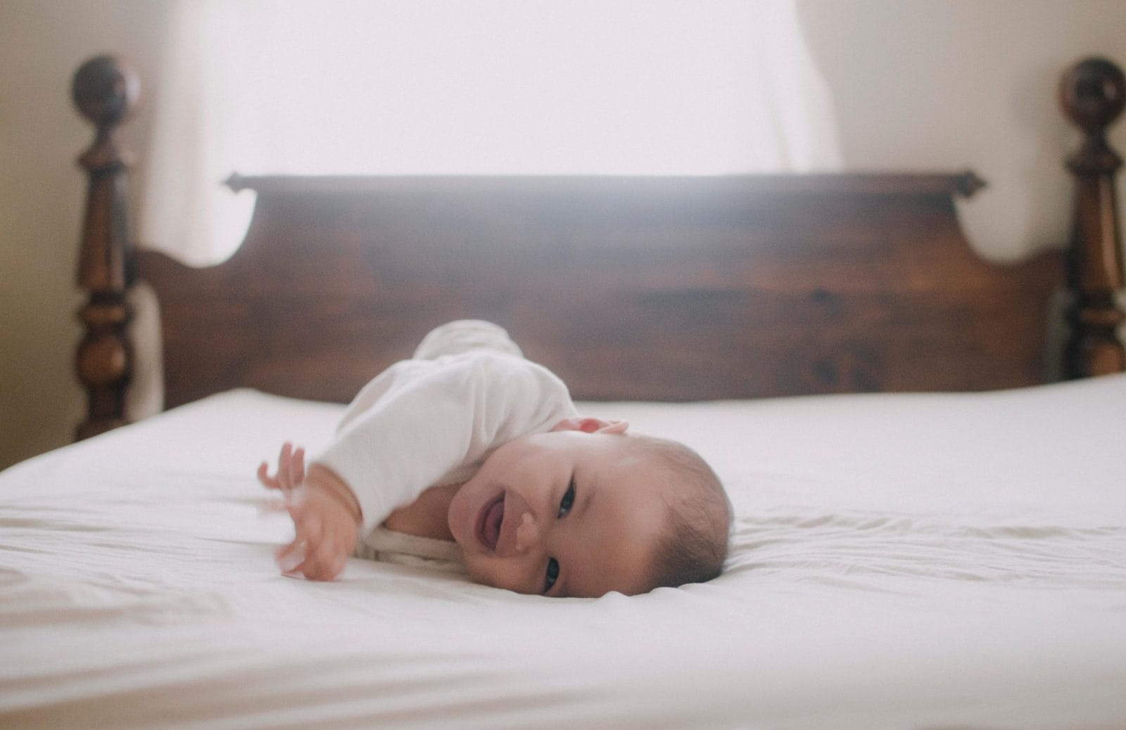 My babies taught me to stop worrying about milestones and just enjoy the moment baby laying on the bed