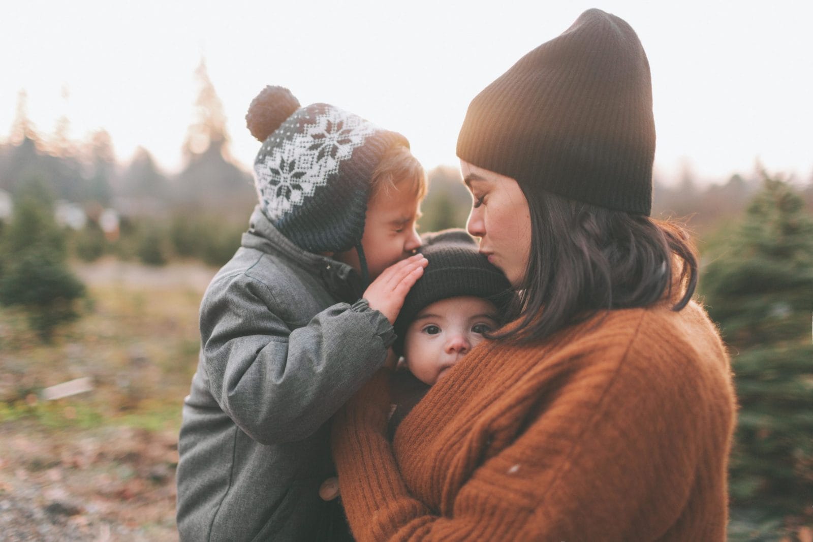 All I want for this year is to be predictable mom kissing two son on top of the head
