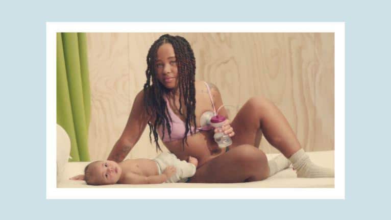 Tommee Tippee released a powerful ad to destigmatize baby feeding—and it’s already been banned in one country 🙄 woman pumping while baby lays in front of her