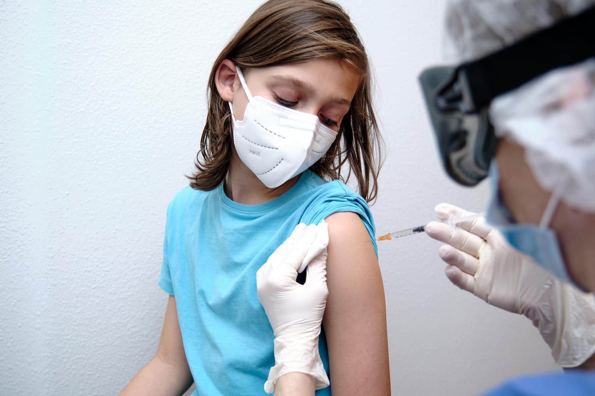 Pfizer seeks to start vaccinating kids ages 2-11 in September child getting a shot