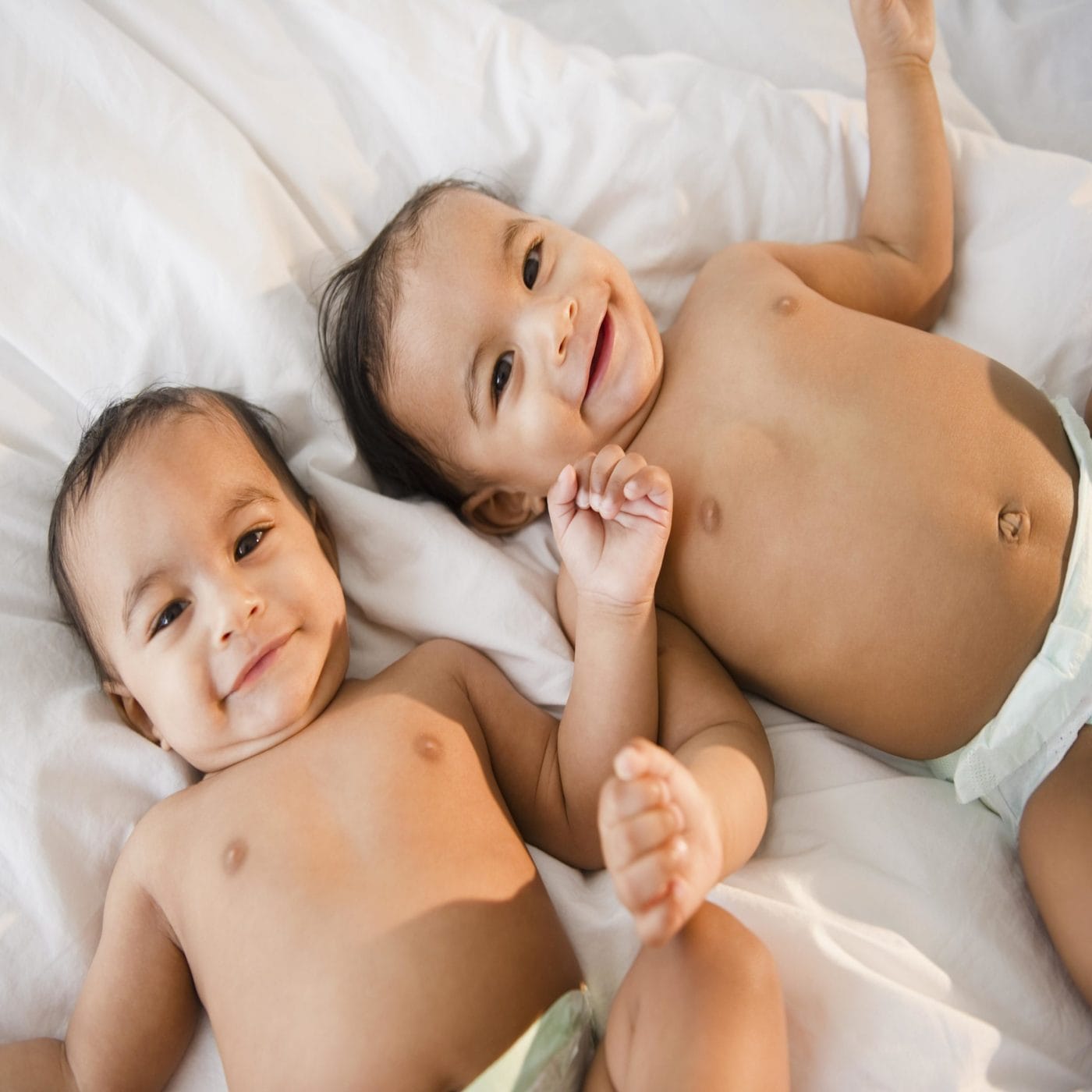 50+ baby names for your little companions born during Gemini season two babies laying in bed