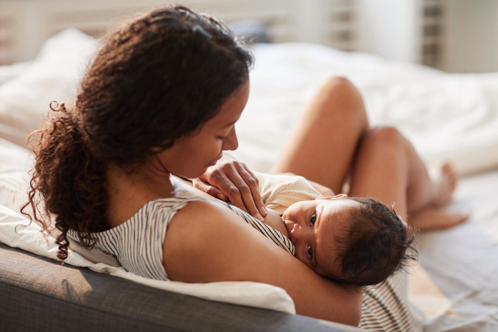 22 things moms wish they knew about breastfeeding before baby arrived mom breastfeeding baby on bed