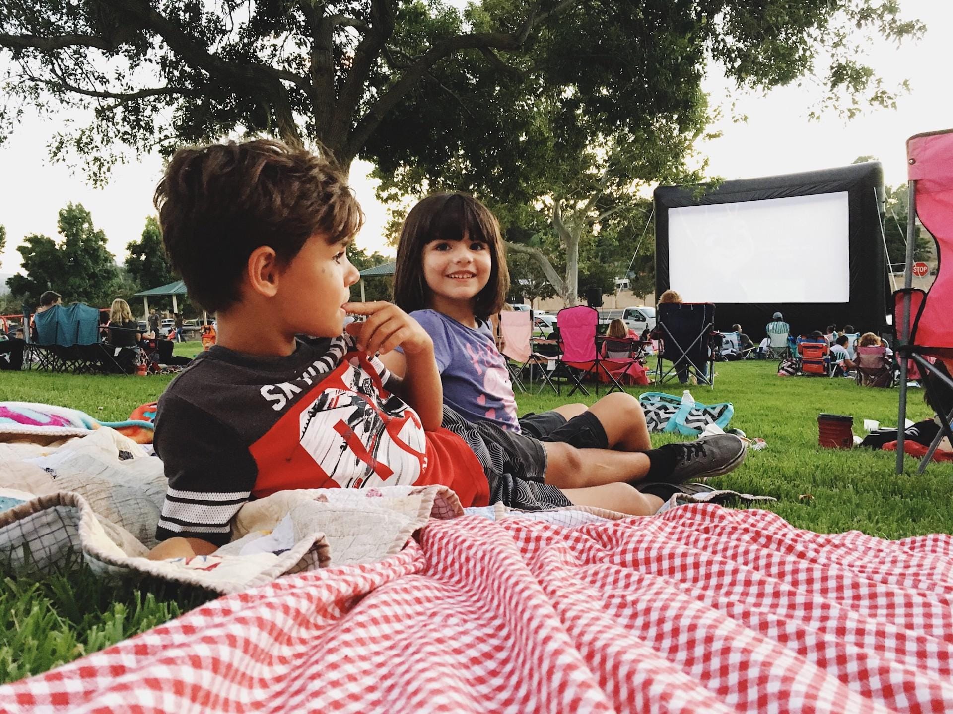 The ultimate summer bucket list for your family kids eating at a picnic table- summer bucket list ideas
