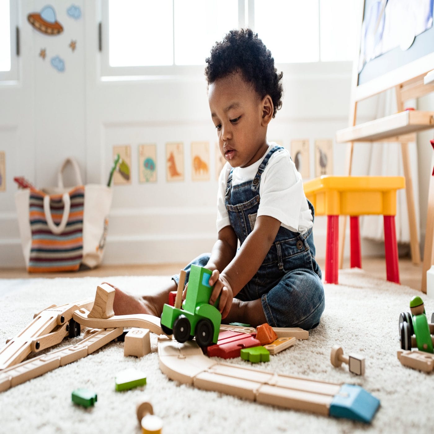 7 positive phrases to boost your toddler’s brain development toddler playing with toys on the floor