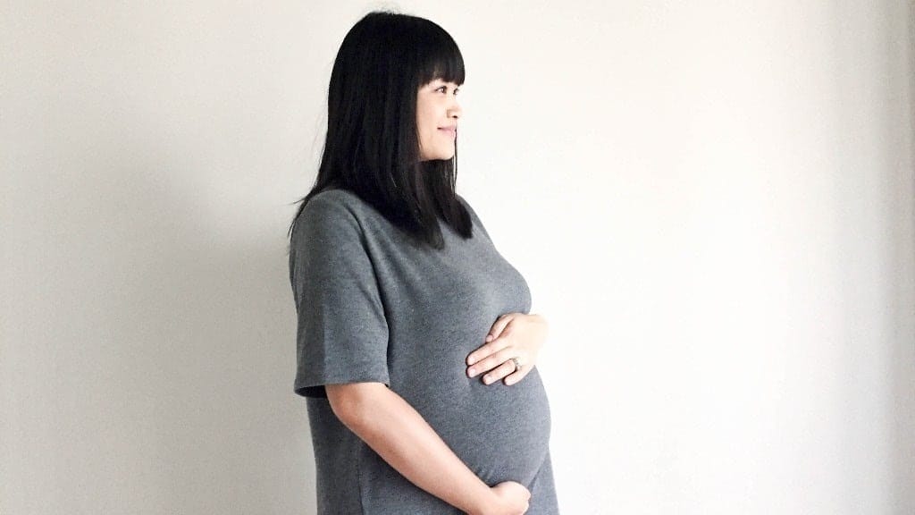 5 amazing things your baby is doing in your third trimester pregnant woman hugging her belly - what your body is doing in the third trimester