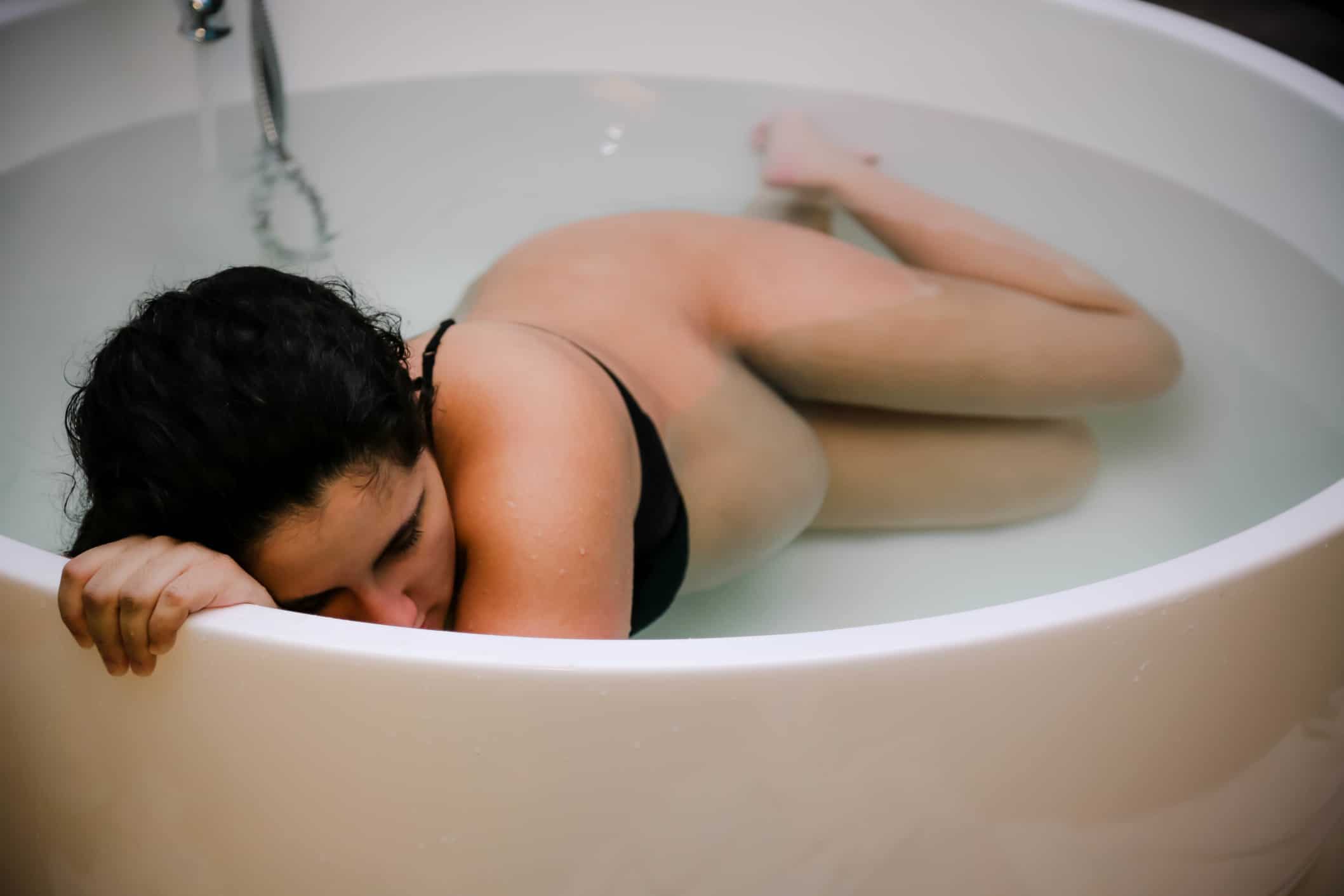Pregnant mamas are the ultimate endurance athletes, research confirms woman in tub during labor - pregnant people are endurance athletes