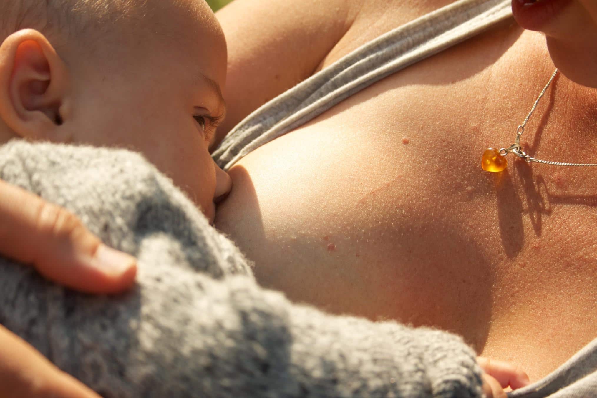 What is cluster feeding—and how do I deal with it? close up of baby breastfeeding