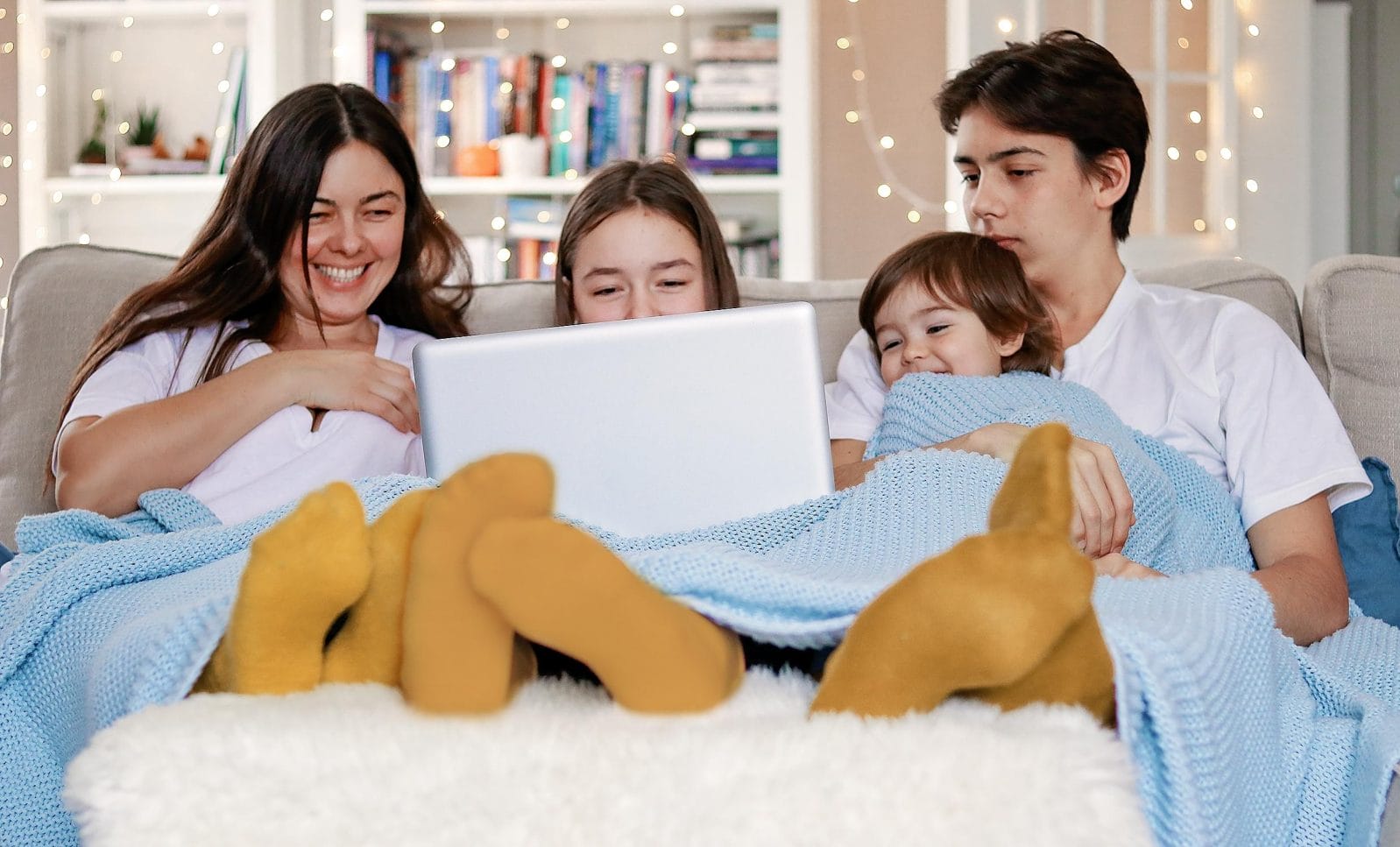 11 movies your whole family will enjoy family watching a movie together on a laptop