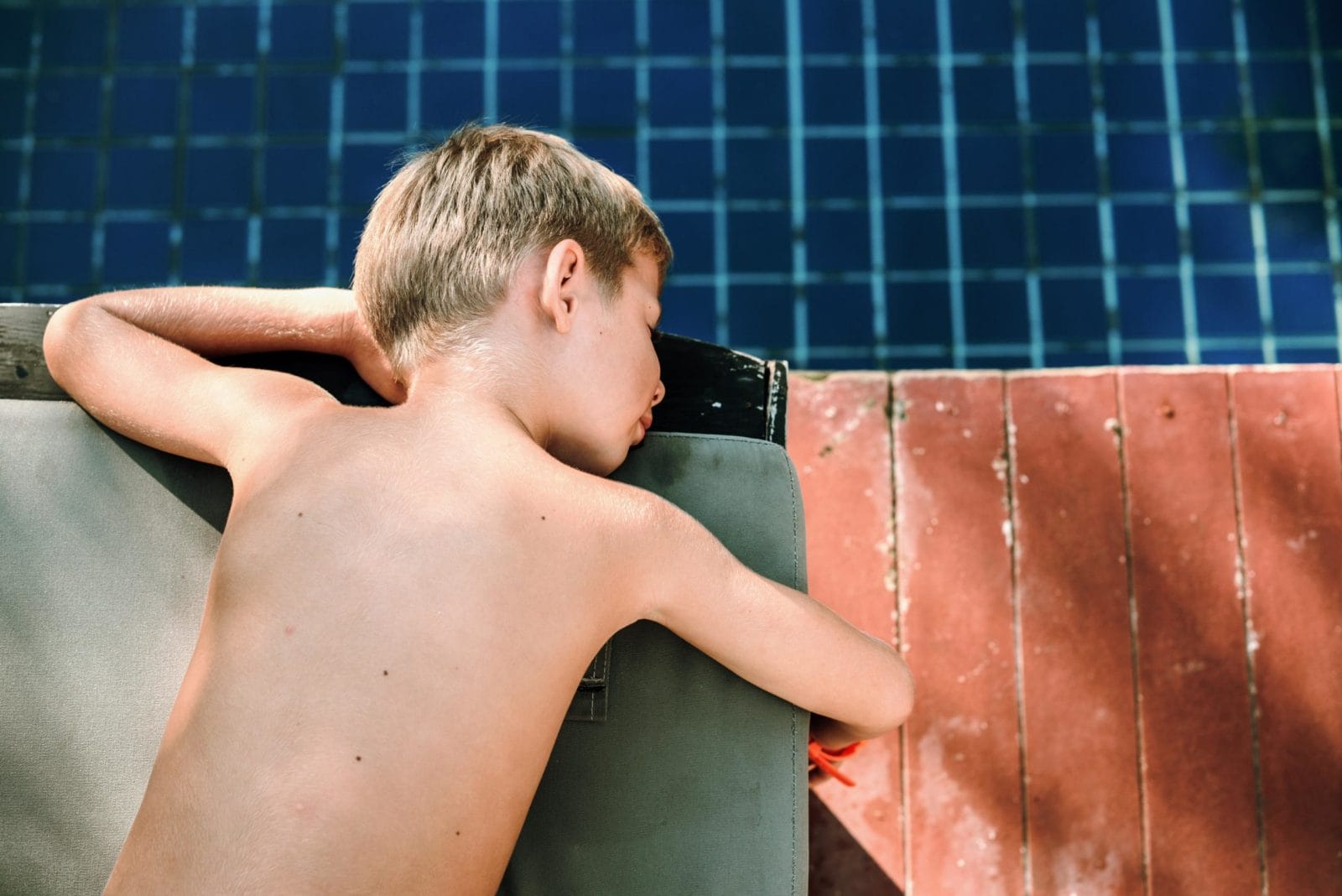 These children are most at risk of drowning, according to new report child dipping his hand into a pool