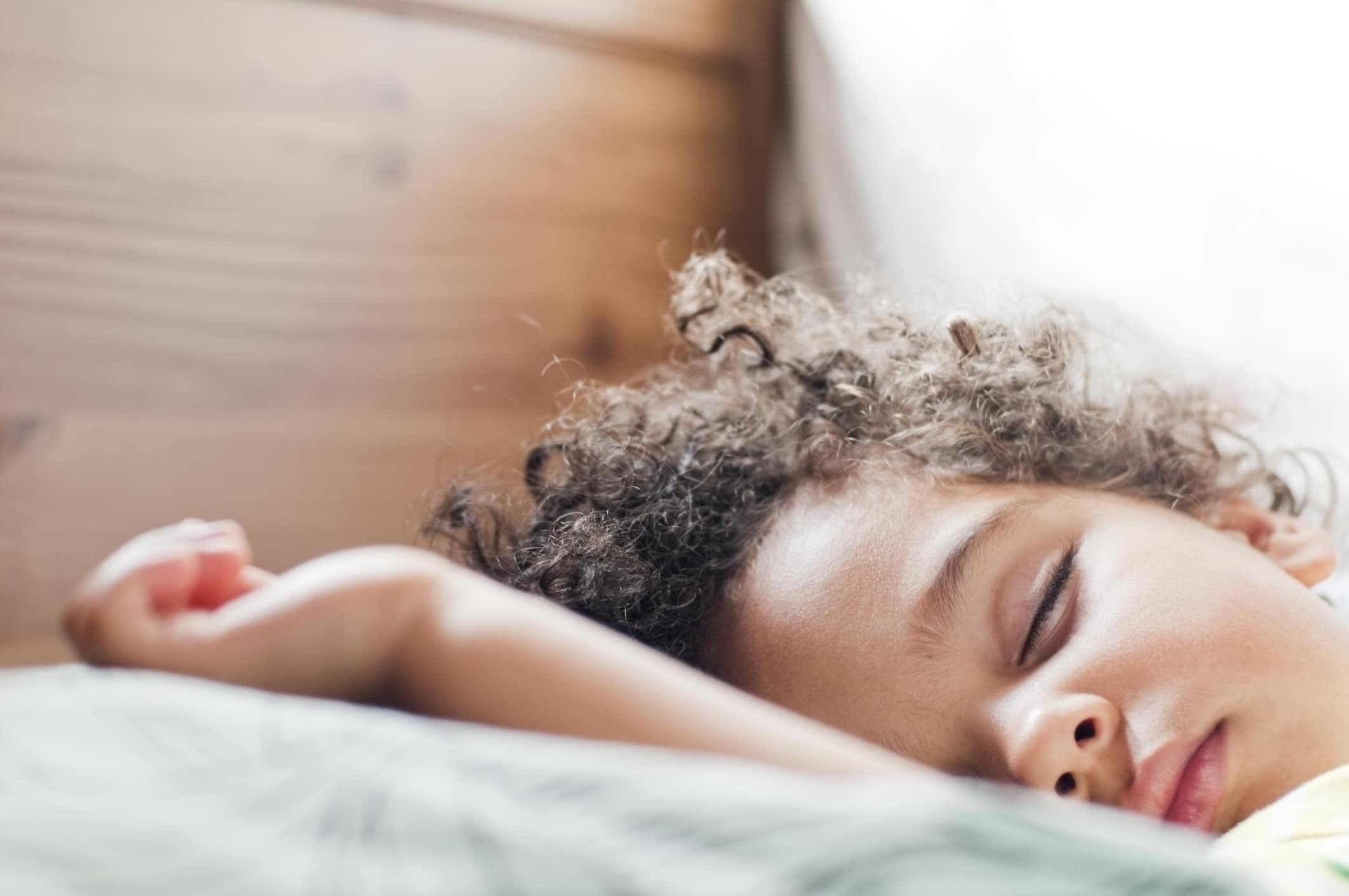 It’s science: Early bedtimes—and the routines behind them—make *everyone* happier little boy sleeping in bed