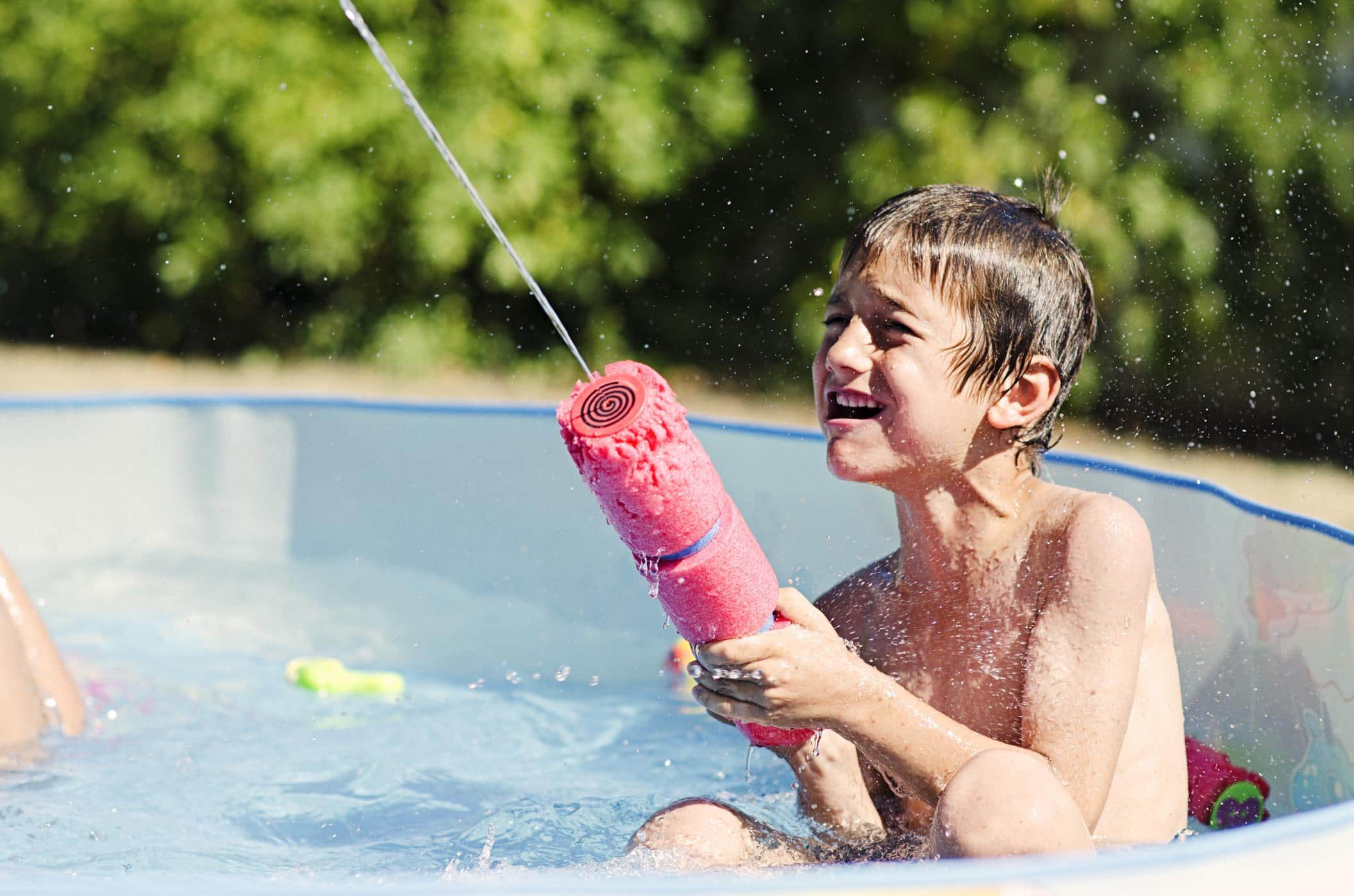 What every family with a kiddie pool needs to know about water safety this summer little kid playing with a pool toy- kiddie pool safety